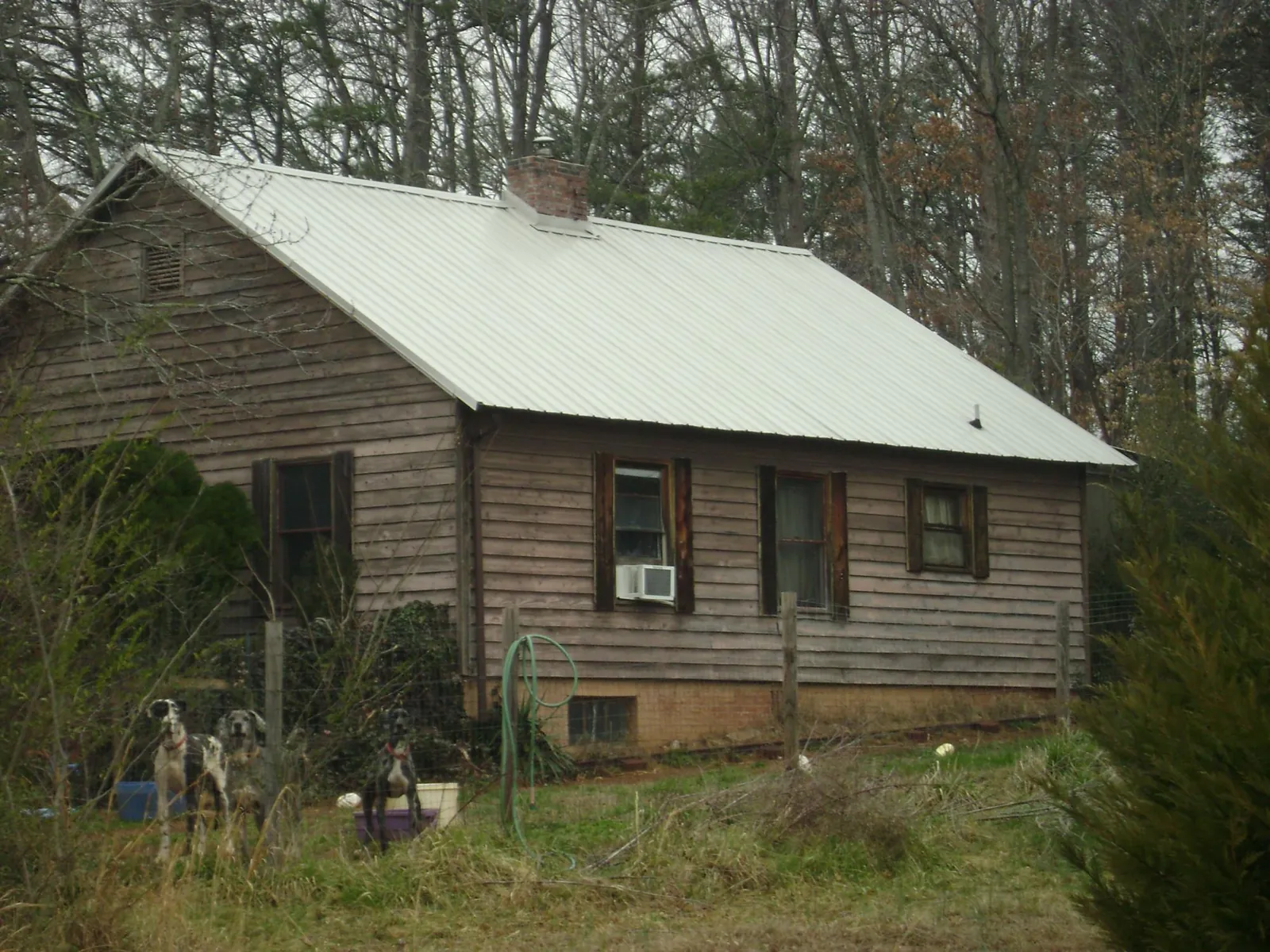 White metal roof on an old wood sided farmhouse, from a Asphalt Shingle Roof Repair job in Round Hill